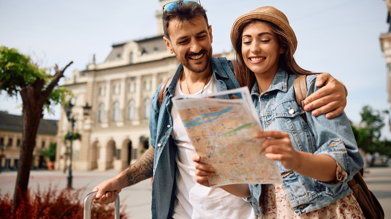 Two travelers looking at a map