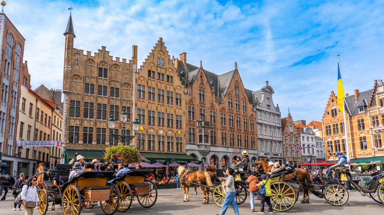 Horsedrawn carriages in a square in Bruges, Belgium