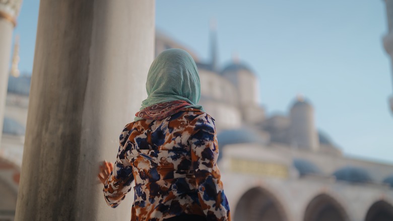 Woman with hair covering in grounds of mosque