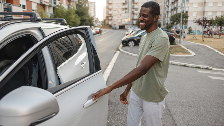 Man opening a car door