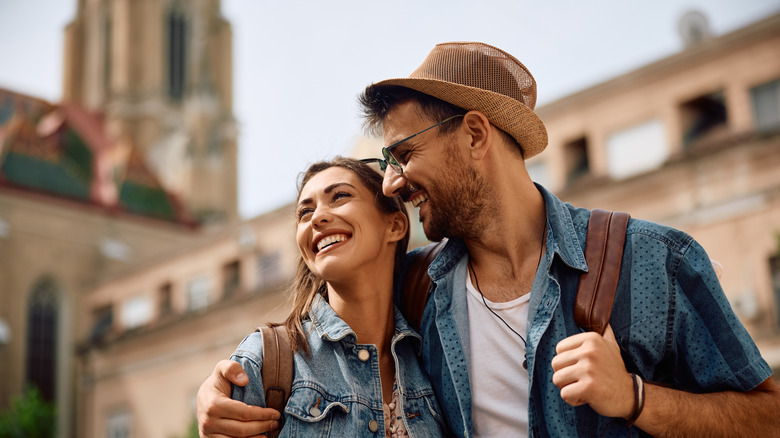 Two smiling tourists in a European city