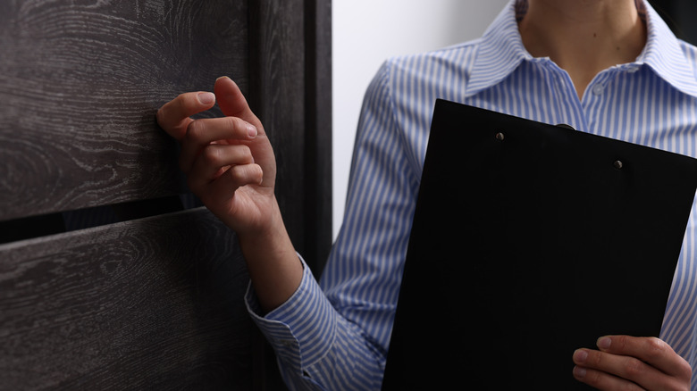 Someone knocking on a hotel room door