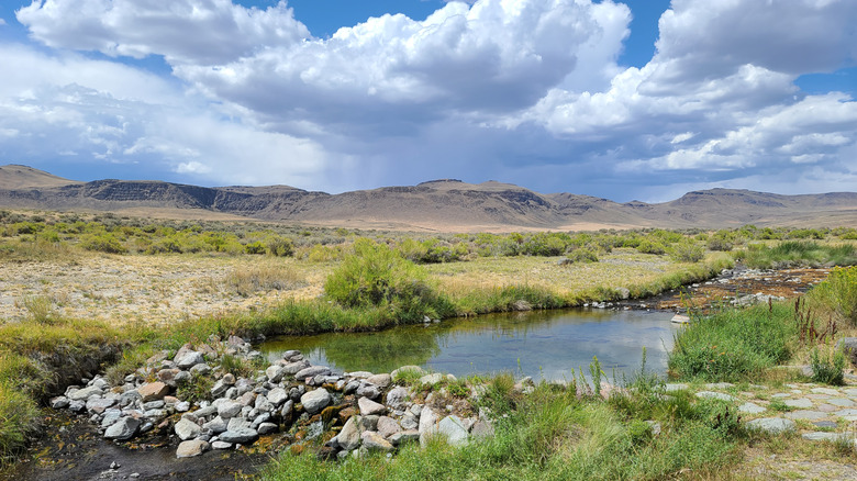 natural hot springs built up with rock retaining wall