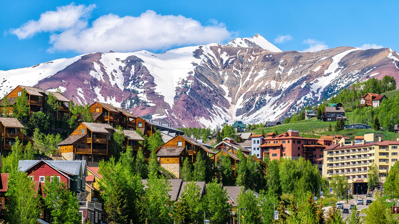 The cabins and resorts of Crested Butte against the backdrop of snow-capped peaks