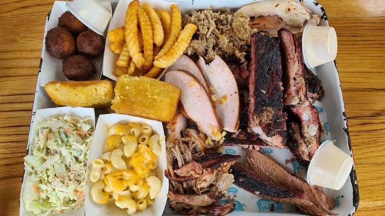 A whole hog  barbecue meat combo plate with classic Southern sides at Rodney Scott's BBQ in Charleston, South Carolina.
