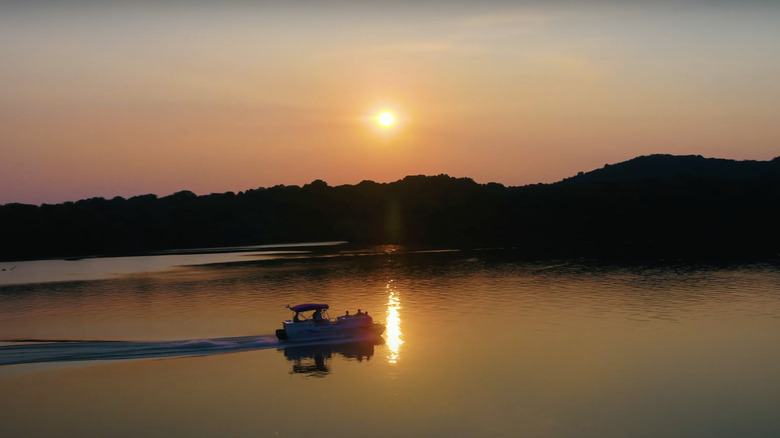 Pontoon boat on Cordell Hull Lake at sunset