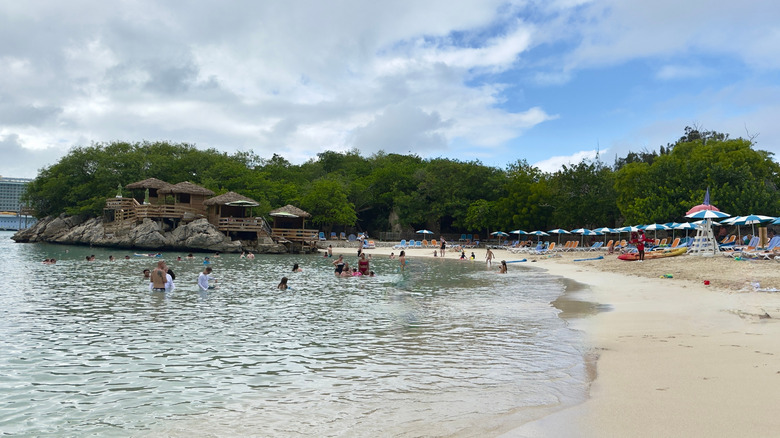 A beach in Labadee with people in the water