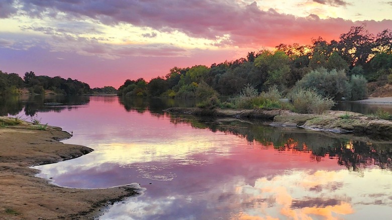 Vibrant pink and purple sunset over the American River in Rancho Cordova, California