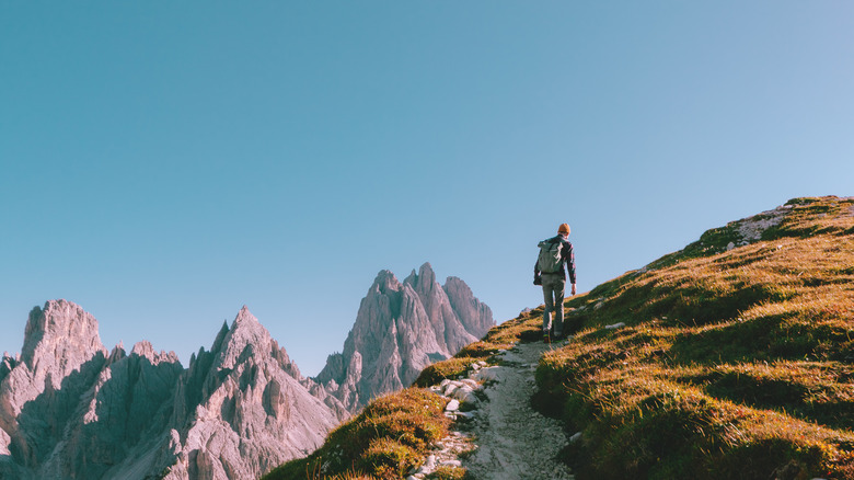 person hiking alone mountain peaks