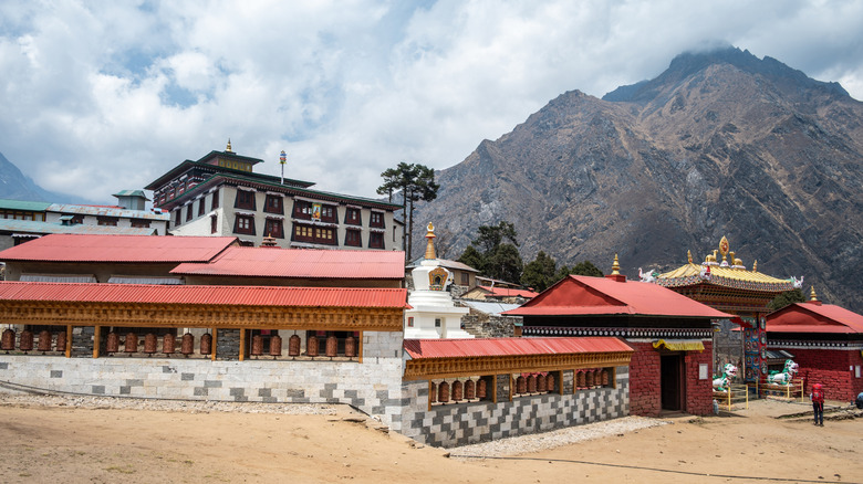 The buildings of the Tengboche Monastery stand under rugged mountain peaks