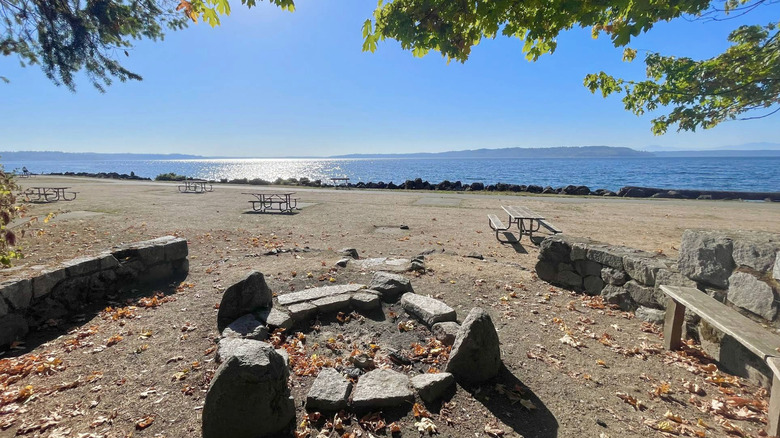 fire pit and benches with tables ovelrooking the water in Saltwater State Park, Washington