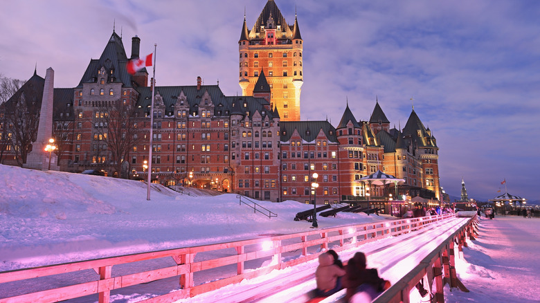 A winter scene with Quebec City's Frontenac Castle illuminated at dusk