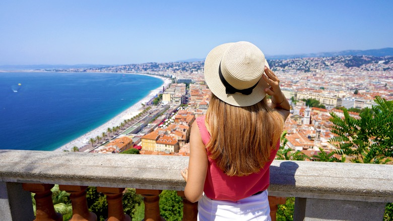 Woman on bridge overlooking costal city
