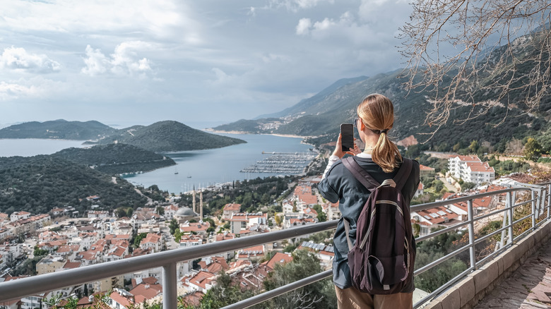 A woman taking pictures of a view