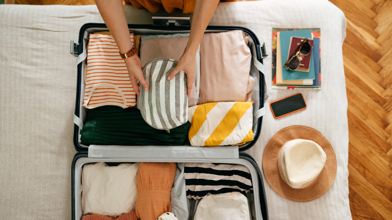 A person packing for a trip