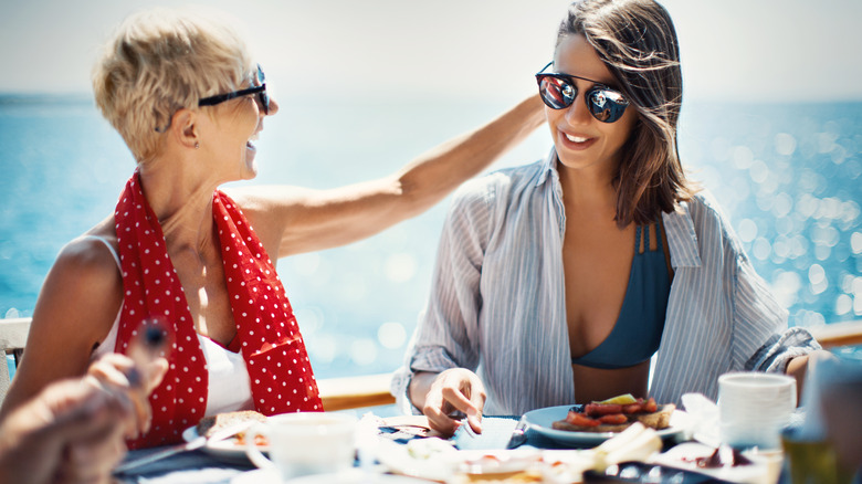 A mother and daughter eating on a cruise
