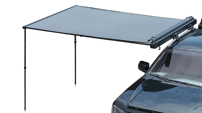 A close up of the BeneHike Magnetic Pull-Out awning attached to the roof of a vehicle against a white background.