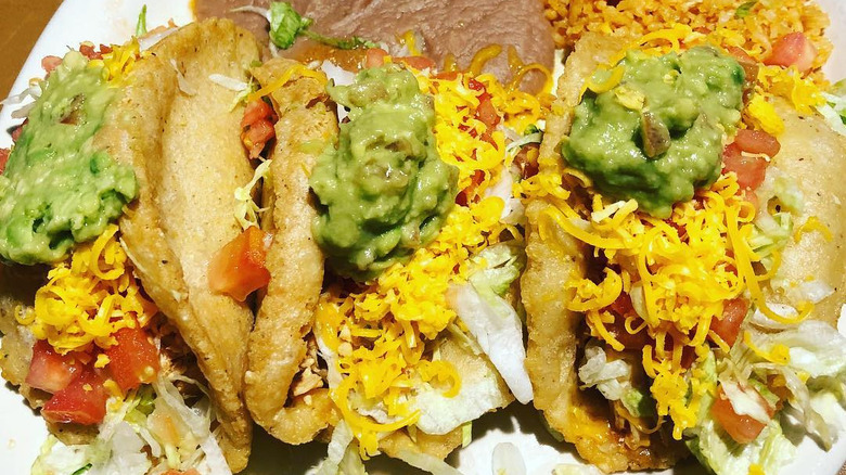 A close up of three Henry's puffy tacos