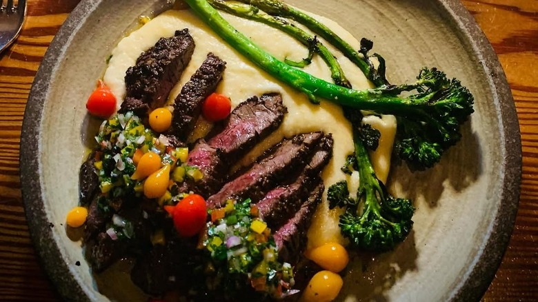 Steak and broccolini dish from Bliss Restaurant