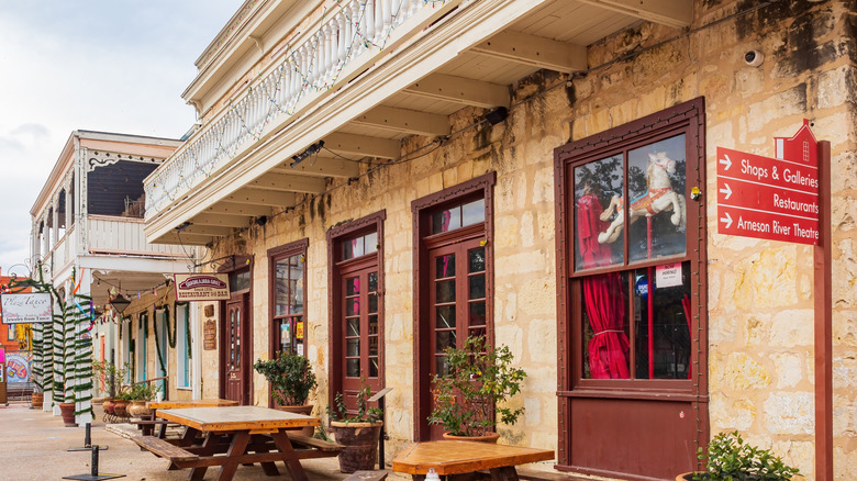 Building in La Villita with sign pointing to shops, galleries, and restaurants in San Antonio, Texas
