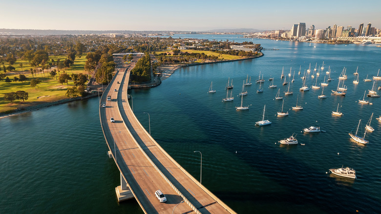 A coastal view of San Diego, California, with boats and a bridge roadway