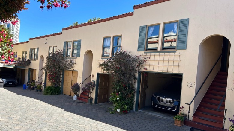 The courtyard at San Francisco's Marina Motel with garages under each room and blooming plants.