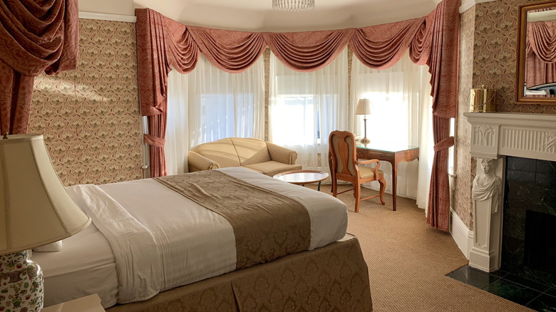 Inside a room of the Hotel Majestic in San Francisco with sunny bay windows