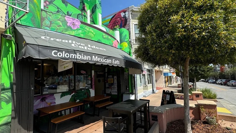 A mural of tropical plants painted on the facade of a Colombian Mexican restaurant in San Francisco.