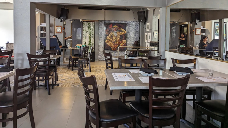 Tables and artwork inside Casa Emilio in Hato Rey