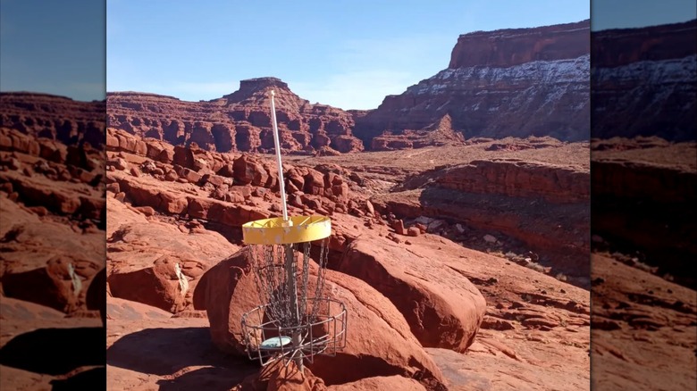 Disc golfing basket in front of stunning red rock formations