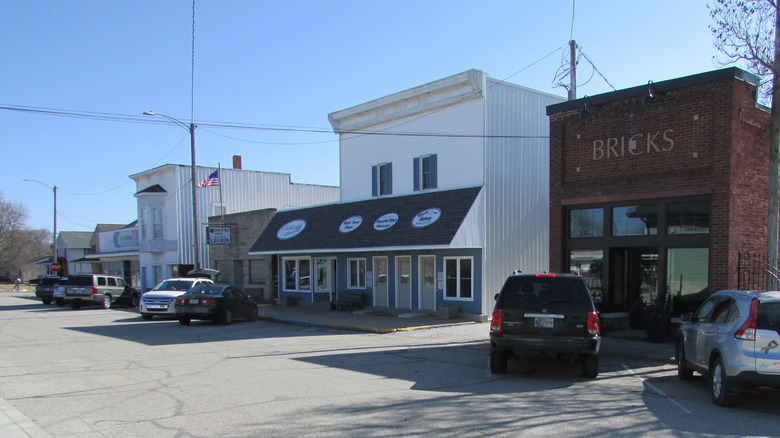 Cars are parked in front of old-fashioned buildings in Remington, Indiana