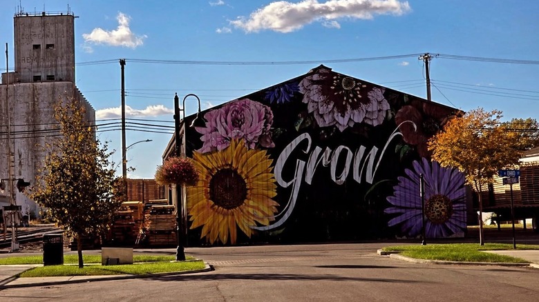 A building with a floral mural on a sunny day in Remington, Indiana