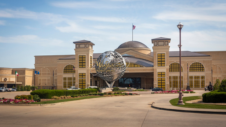 Exterior of WinStar's domed entrance with a giant metal globe monument that reads "WinStar World"