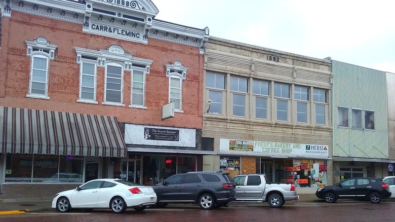 Cars parked next to charming old brick buildings in downtown Lexington, NE