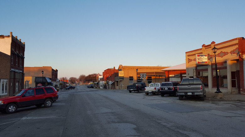 Main Street lined with cars and shops at sunset in Anita, Iowa