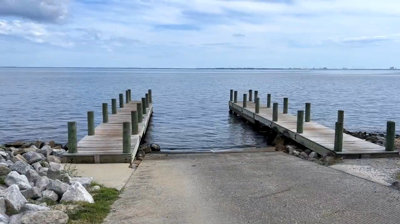 Two wooden piers straddling a boat ramp at Choctaw Beach Park in Florida