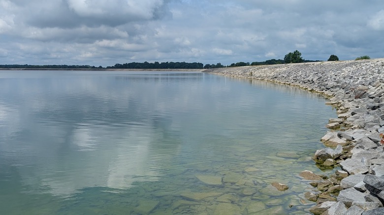 Willard City Reservoir in Willard, Ohio, with a rocky shoreline on a cloudy day