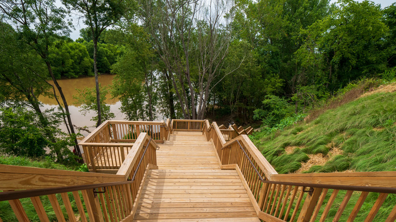 A wooden staircase leads down to the river bank at Yadkin River Park