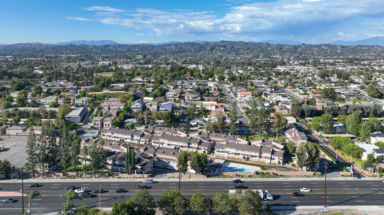 Aerial view of La Habra with trees, houses, and rolling hills in the background