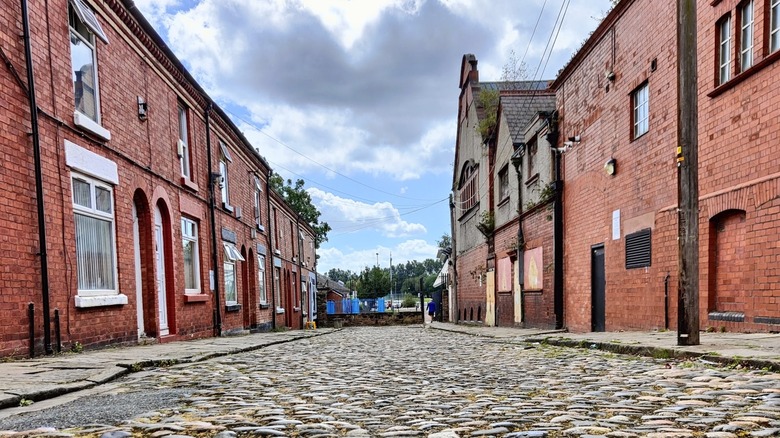 Cobblestoned street lined by historic brick buildings Prescot