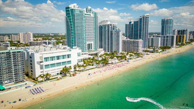 Aerial view of Hallandale Beach showing the shoreline, water, and buildings.