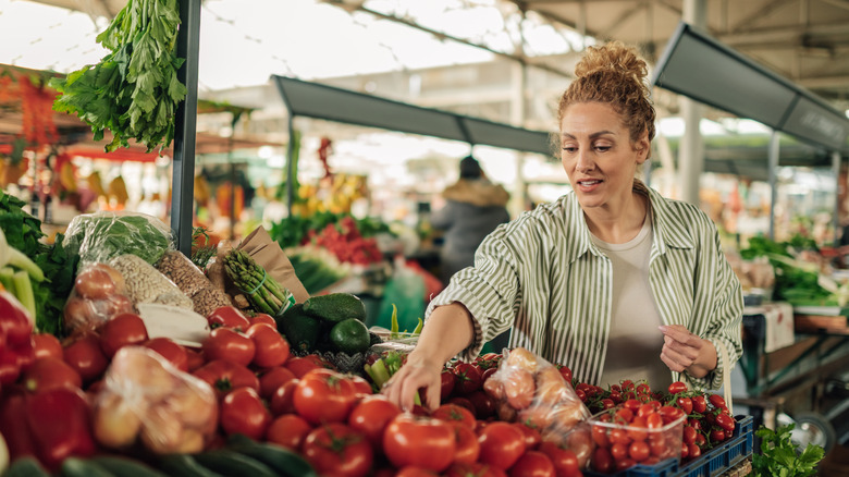 Woman browsing for vegetables at a farmers market