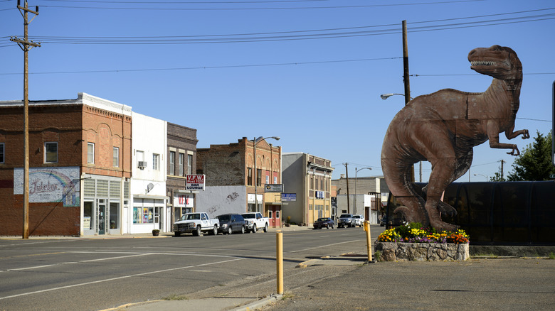 A dinosaur sign sits in downtown Glendive, Montana