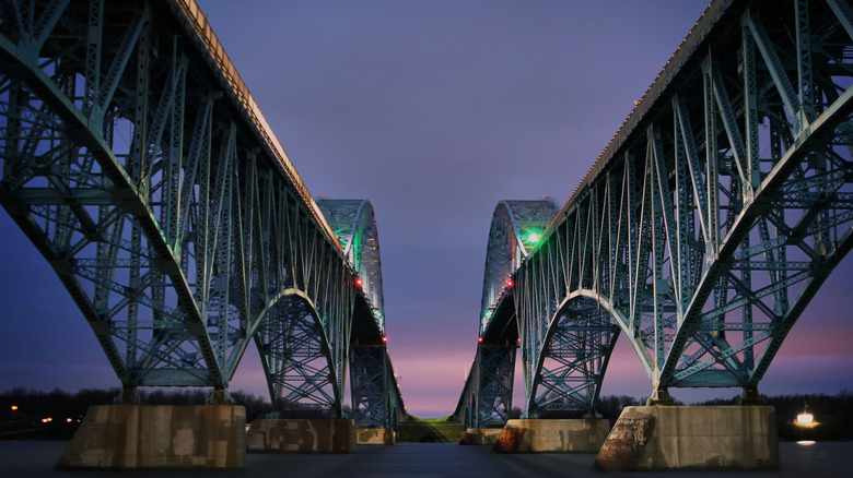 A two way bridge at night over the river