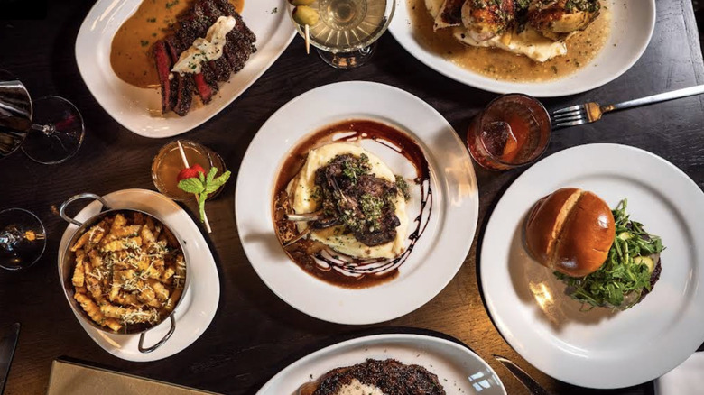 Overhead shot of several plates of food on a table at the Marrow Restaurant in Gretna, Nebraska.