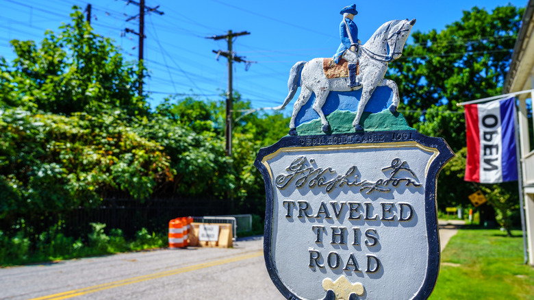A sign pointing commemorating the Revolutionary War history of Perryville, Maryland, with a figure of a man on a horse