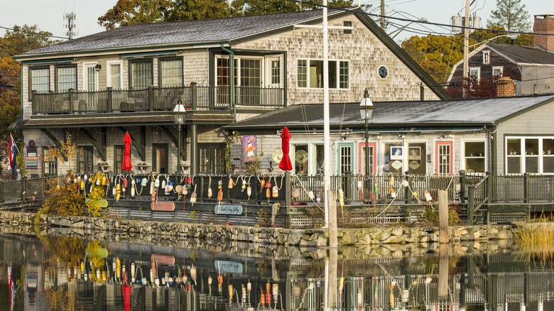 Coastal home adorned with buoys in Wickford on the water in daytime
