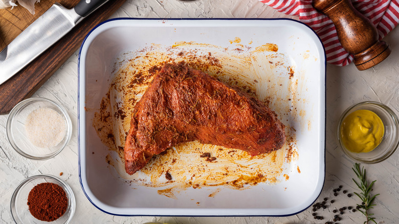rubbing Santa Maria-style sauce on tri-tip steak