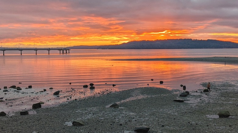 Sunset over Puget Sound, as viewed from the fishing pier and marina in Des Moines, Washington.
