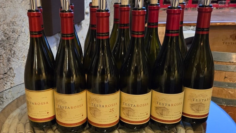 Bottles of open wine on a glass table at Testarossa Winery, in Los Gatos, California.